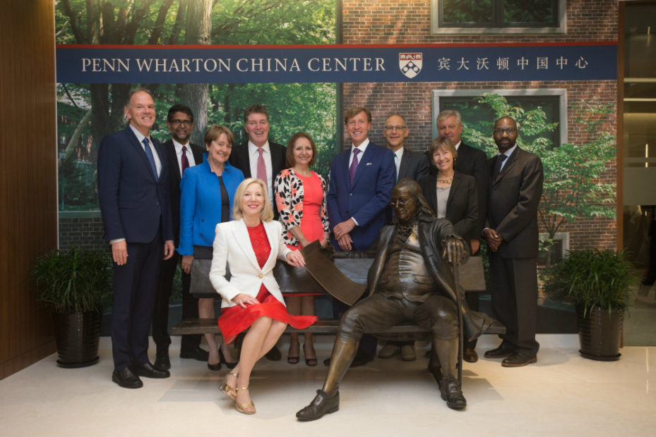 Pictured on the Ben on the Bench sculpture at the Penn Wharton China Center in Sept. 2015: Penn President Amy Gutmann (seated) with (from left to right) Wharton Dean Geoffrey Garrett; Penn Engineering Dean Vijay Kumar; former PennDesign Dean Marilyn Jordan Taylor; former Penn Dental Dean Denis F. Kinane; Penn Nursing Dean Antonia Villarruel; Perelman School of Medicine Dean J. Larry Jameson; Vice Provost for Global Initiatives Ezekiel Emanuel; Graduate School of Education Dean Pam Grossman; Penn Arts and Sciences Dean Steven J. Fluharty; and School of Social Policy & Practice Dean John L. Jackson Jr.