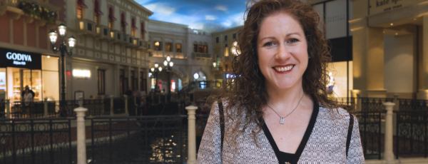Jaime standing before the water canal in an indoor mall