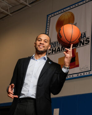 Man in a suit holding a basketball 